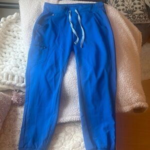 Figs jogger bottoms with some wear and tear